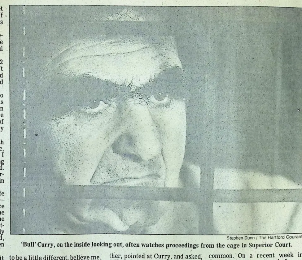 Hartford Courant photo by Stephen Dunn, close-up of Bull Curry's face through the bars of the Superior Court cage, on the inside looking out